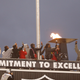 Oakland Raiders running back Marshawn Lynch, right, lights a ceremonial torch for former team owner Al Davis before an NFL football game between the Raiders and the Denver Broncos in Oakland, Calif., Monday, Dec. 24, 2018.